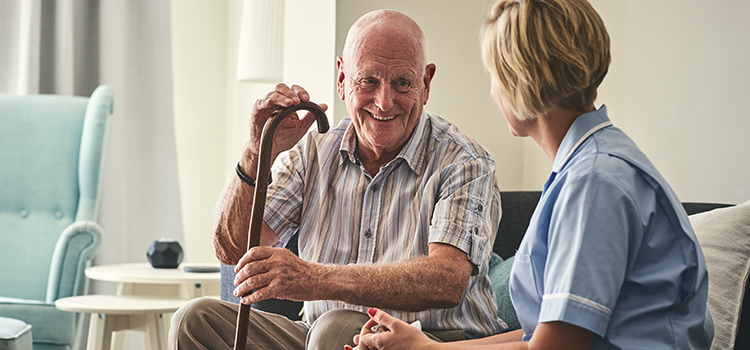 palliative care nurse assisting a senior citizen