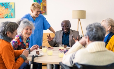 seniors laughing at table adult day health services near syracuse ny