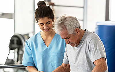 therapy after surgery image of therapist assisting elderly patient