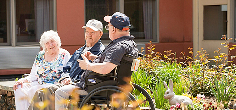 long term care facilities near morrisville ny image of elderly men and woman sitting outside