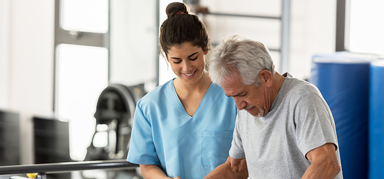 fall prevention for the elderly near morrisville ny image of physical therapist assisting senior
